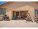 Covered back patio includes a ceiling fan, space for outdoor furniture, and access to the backyard at 17693 W Lincoln St, Goodyear, AZ 85338