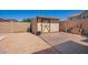 The backyard features a storage shed with double doors and a gravel landscape and cement pad at 17693 W Lincoln St, Goodyear, AZ 85338