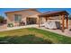 Backyard features covered patio, well-maintained lawn, and BBQ, perfect for enjoying outdoor gatherings at 17693 W Lincoln St, Goodyear, AZ 85338