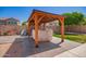 Backyard featuring a covered jacuzzi, a paved area, and a block fence, creating a private outdoor retreat at 17693 W Lincoln St, Goodyear, AZ 85338