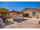 Backyard with covered patio featuring a covered jacuzzi and an outdoor grill, perfect for entertaining guests at 17693 W Lincoln St, Goodyear, AZ 85338