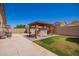 Spacious backyard with a covered patio, lush grass, and BBQ, ideal for outdoor enjoyment and entertaining at 17693 W Lincoln St, Goodyear, AZ 85338