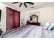 Bedroom showcasing a ceiling fan, dresser with mirror and comfortable bed with patterned bedding at 17693 W Lincoln St, Goodyear, AZ 85338