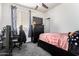 Bedroom featuring a black ceiling fan, a black dresser and a small black bed frame at 17693 W Lincoln St, Goodyear, AZ 85338