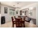 Chandelier hangs over the dining room, which has an open floor plan into the living room at 17693 W Lincoln St, Goodyear, AZ 85338