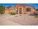 Inviting single-story house with a desert landscape, two green bushes, and a convenient two-car garage at 17693 W Lincoln St, Goodyear, AZ 85338