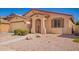 Inviting single-story house with a desert landscape, two green bushes, and a convenient two-car garage at 17693 W Lincoln St, Goodyear, AZ 85338
