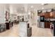Bright kitchen with stainless steel appliances, bar seating and an open-concept view into the dining area at 17693 W Lincoln St, Goodyear, AZ 85338