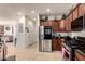 Open kitchen area featuring stainless steel appliances, granite countertops, and tiled flooring at 17693 W Lincoln St, Goodyear, AZ 85338