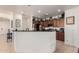 Well-lit kitchen with wood cabinetry and stainless steel appliances; a breakfast bar is available at 17693 W Lincoln St, Goodyear, AZ 85338