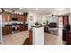 Open-concept kitchen has stainless steel appliances, granite countertops, and a breakfast bar at 17693 W Lincoln St, Goodyear, AZ 85338
