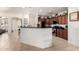 Spacious kitchen with dark wood cabinets, stainless steel appliances, and a breakfast bar at 17693 W Lincoln St, Goodyear, AZ 85338