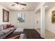Cozy living room with hardwood floors, modern gray sofa, neutral walls, and bright natural light at 17693 W Lincoln St, Goodyear, AZ 85338