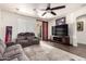 Comfortable living room features a ceiling fan, plush seating, and a large television for entertainment at 17693 W Lincoln St, Goodyear, AZ 85338
