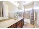 Bright bathroom featuring single sink vanity and shower-tub combination at 17975 W Willow Dr, Goodyear, AZ 85338