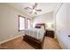 Bright bedroom featuring carpet, shutters, and ceiling fan at 17975 W Willow Dr, Goodyear, AZ 85338