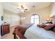 Comfortable bedroom featuring an arched window, sliding-door closet, and neutral-colored walls at 17975 W Willow Dr, Goodyear, AZ 85338