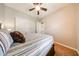 Cozy bedroom features neutral walls, ceiling fan, and closet with sliding doors at 17975 W Willow Dr, Goodyear, AZ 85338