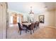 Elegant dining room with natural lighting, stylish furnishings, and an open doorway at 17975 W Willow Dr, Goodyear, AZ 85338