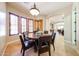 Well-lit dining area with a round table, chairs, and beautiful shuttered windows at 17975 W Willow Dr, Goodyear, AZ 85338