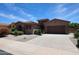 Well-maintained single-story home with a two-car garage, manicured landscaping, and a welcoming entrance at 17975 W Willow Dr, Goodyear, AZ 85338