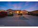 Beautiful single-story home with a well-manicured yard, brick walkway, and a spacious two-car garage at 17975 W Willow Dr, Goodyear, AZ 85338