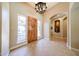 Elegant foyer with a statement chandelier, high ceilings, and views into other living spaces at 17975 W Willow Dr, Goodyear, AZ 85338