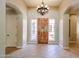 Welcoming foyer featuring tiled floors, a statement chandelier, and bright windows at 17975 W Willow Dr, Goodyear, AZ 85338