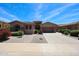 Charming single-story home boasts desert landscaping, a brick walkway, and a two-car garage at 17975 W Willow Dr, Goodyear, AZ 85338