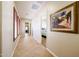 Hallway featuring tile flooring, natural lighting, and wall decor at 17975 W Willow Dr, Goodyear, AZ 85338