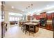 Stylish kitchen with a central island, dark cabinetry, and open access to living area at 17975 W Willow Dr, Goodyear, AZ 85338