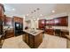 Open kitchen featuring a center island, dark cabinets, and granite countertops at 17975 W Willow Dr, Goodyear, AZ 85338