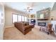 Inviting living area featuring a stone fireplace and a plush sofa at 17975 W Willow Dr, Goodyear, AZ 85338