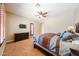 Serene bedroom with a king-size bed, ceiling fan, and plenty of natural light at 17975 W Willow Dr, Goodyear, AZ 85338