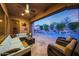 Covered patio featuring comfortable seating and views of a sparkling pool with water feature at 17975 W Willow Dr, Goodyear, AZ 85338
