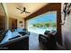 A covered patio features comfortable seating and a view of the gorgeous pool and outdoor area at 17975 W Willow Dr, Goodyear, AZ 85338