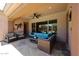 Covered patio with comfortable seating, ceiling fan, and view of pool through the window at 17975 W Willow Dr, Goodyear, AZ 85338