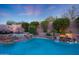 Stunning backyard pool with lush landscaping, a soothing waterfall, and lounge seating for outdoor relaxation at 17975 W Willow Dr, Goodyear, AZ 85338