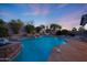 Luxurious backyard pool area with waterfalls, lush greenery, and stone accents for ultimate relaxation at 17975 W Willow Dr, Goodyear, AZ 85338