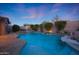 Resort-style backyard with a large pool, multiple lounge areas, and a built-in grill, perfect for entertaining at 17975 W Willow Dr, Goodyear, AZ 85338