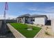 Backyard with a covered patio, artificial turf, decorative gravel, and a privacy fence at 18134 W Creedance Blvd, Surprise, AZ 85387