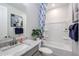 Bathroom with granite countertops, new fixtures, and a shower tub with a curtain at 18134 W Creedance Blvd, Surprise, AZ 85387