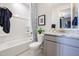 Bathroom features a shower-tub combo, a granite countertop and cabinet at 18134 W Creedance Blvd, Surprise, AZ 85387