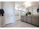 Modern bathroom with a double vanity, granite counters, and a glass-enclosed shower at 18134 W Creedance Blvd, Surprise, AZ 85387