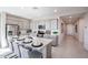 Bright kitchen featuring a large island with granite countertops, stainless steel appliances, and grey cabinets at 18134 W Creedance Blvd, Surprise, AZ 85387