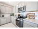Modern kitchen with stainless steel appliances, granite countertops, and ample cabinet space at 18134 W Creedance Blvd, Surprise, AZ 85387