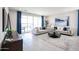 Bright living room showcasing stylish sofas, geometric coffee table, and access to an outdoor patio at 18134 W Creedance Blvd, Surprise, AZ 85387