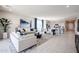 Spacious open-concept layout connecting the kitchen, dining, and living room, with modern decor and ample natural light at 18134 W Creedance Blvd, Surprise, AZ 85387