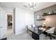 A bright office with a large desk and shelves and a door leading to another room at 18134 W Creedance Blvd, Surprise, AZ 85387