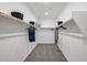 Large walk-in closet with shelving on each side and neutral colored carpet at 18134 W Creedance Blvd, Surprise, AZ 85387